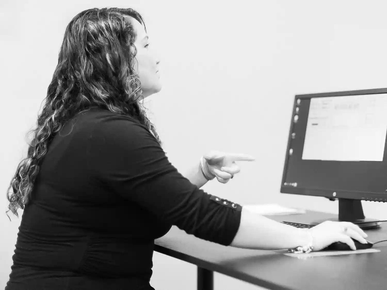 woman performing a Parkinson's evaluation on a computer